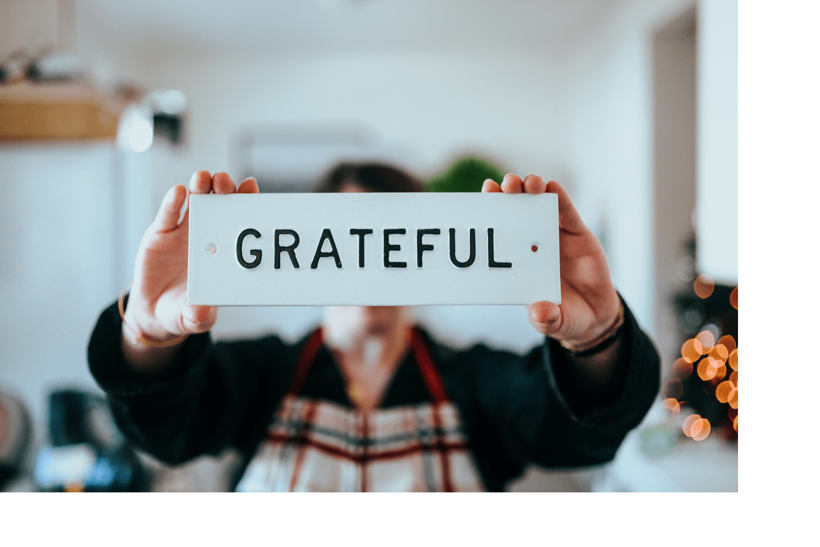 woman holding grateful sign