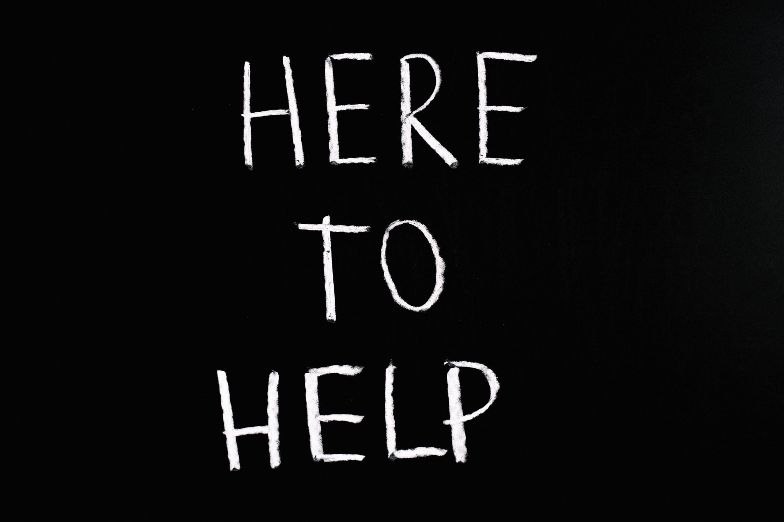 pexels-anna-tarazevich-5697255 "here to help" written in chalk