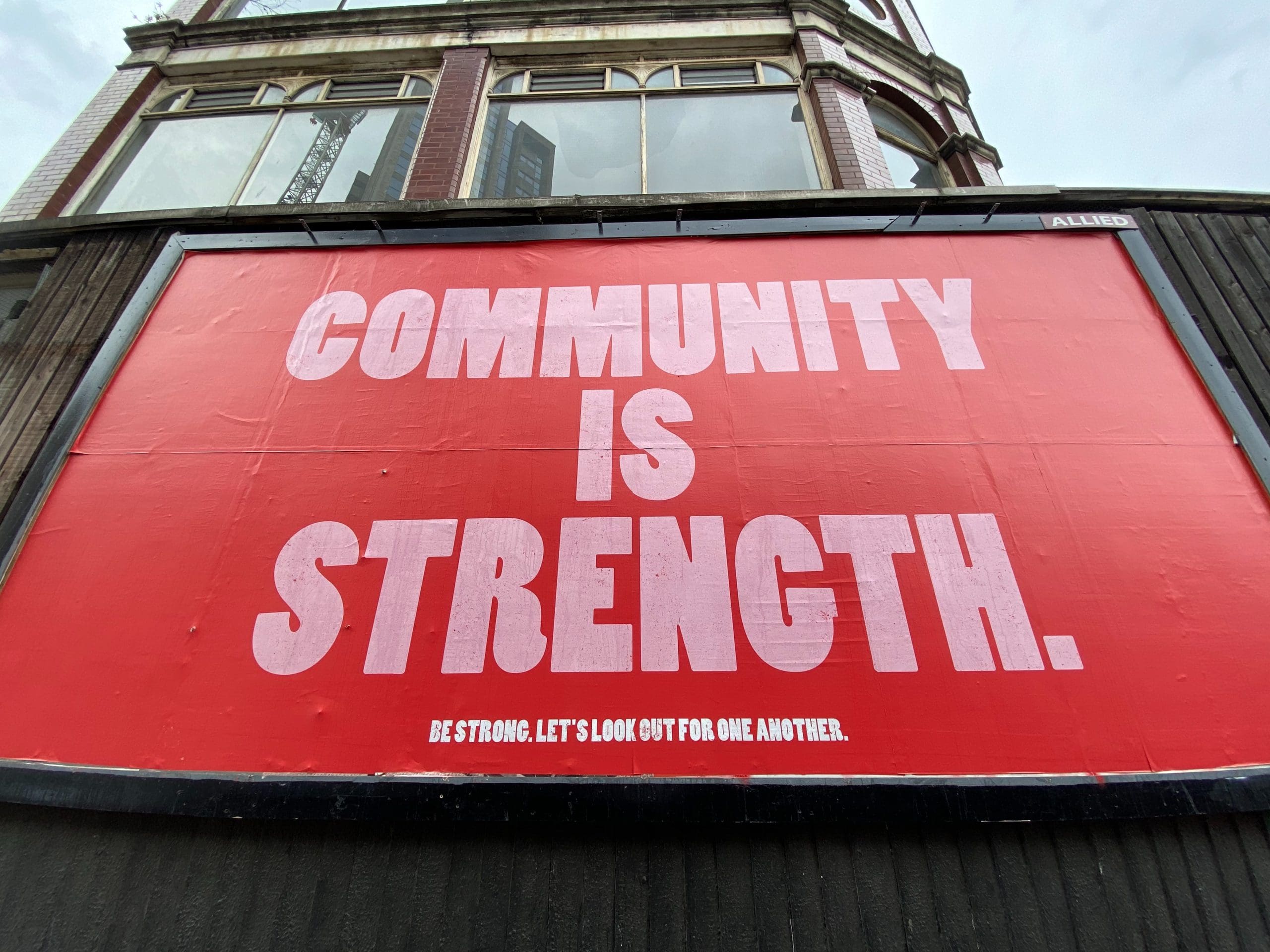 john-cameron-_5IRj1F2rY-unsplash 'community is strength' poster